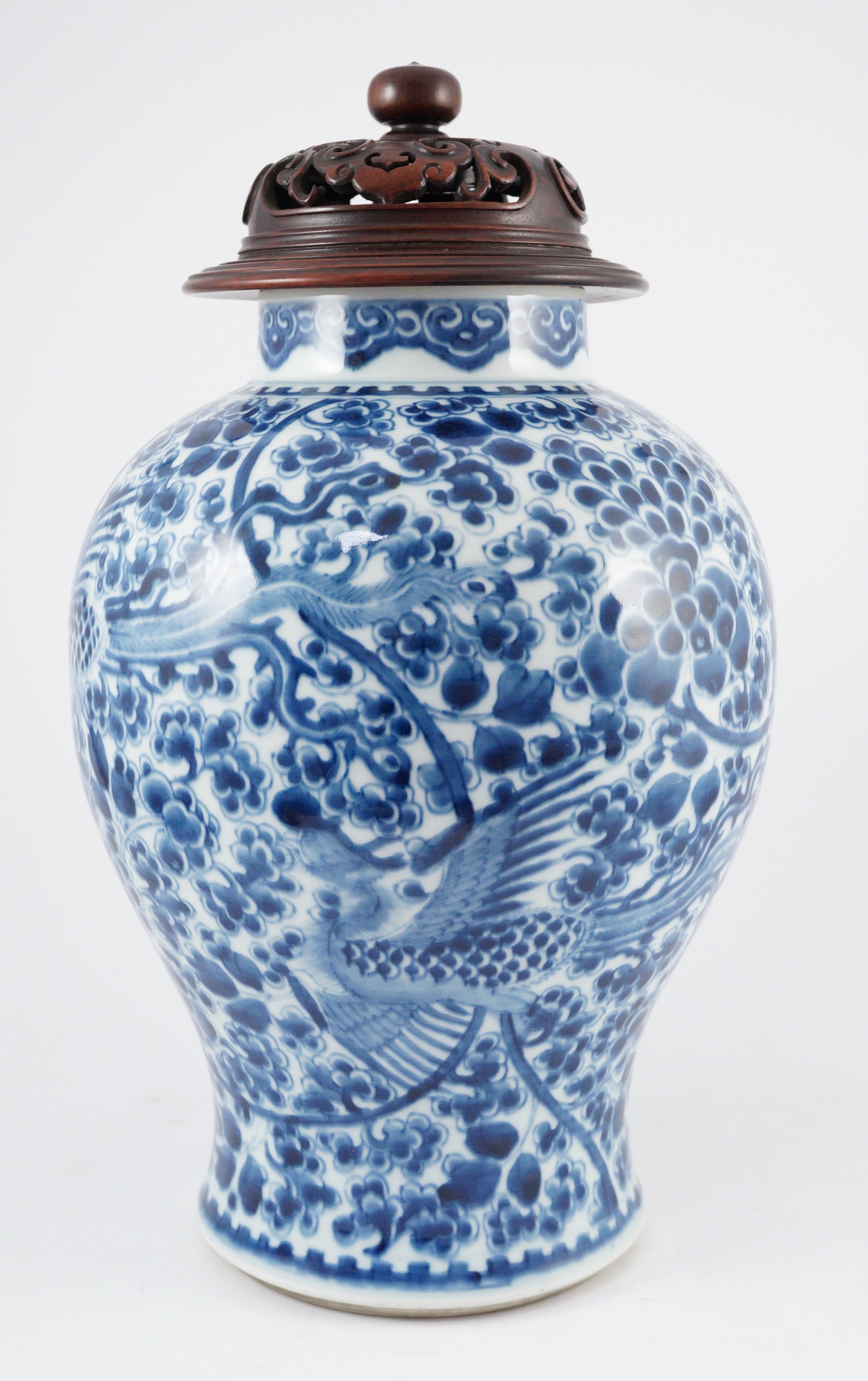 A Chinese blue and white ‘phoenix and peony’ baluster jar, Kangxi period, with a later wood cover, 36cm high excluding later wood cover